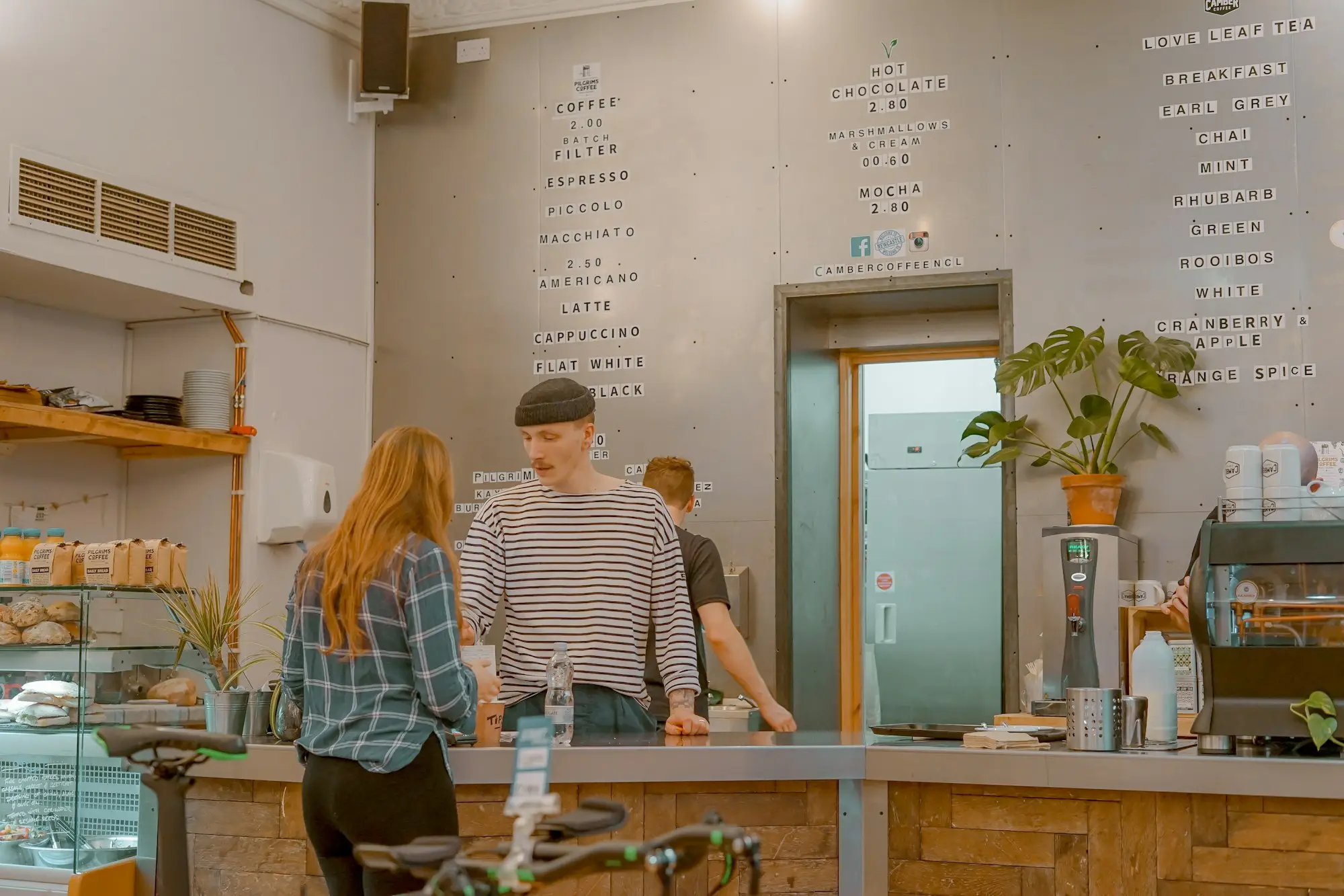Cafe owner and staff behind the counter at the end of the day