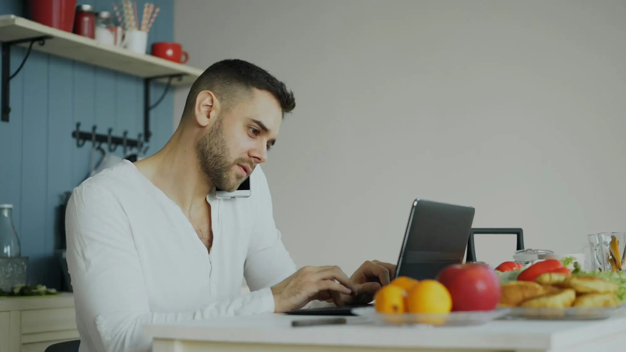 Business owner working on a laptop at the kitchen table in the evening