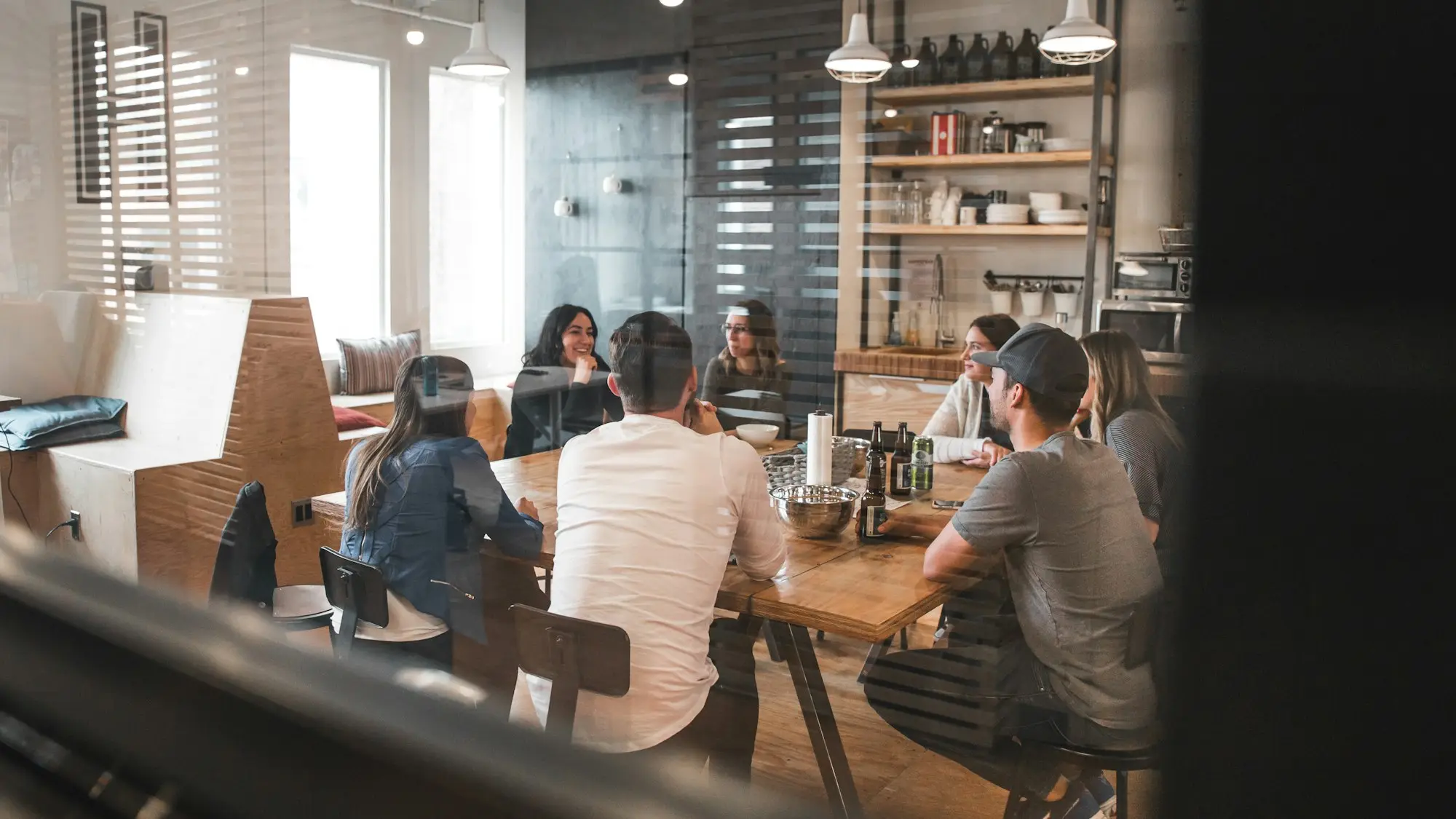 Team gathered around workbenches for a morning catch-up